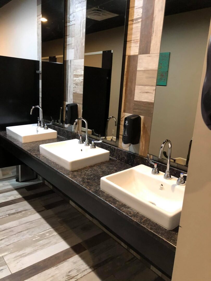 Dark bathroom countertops with white sinks