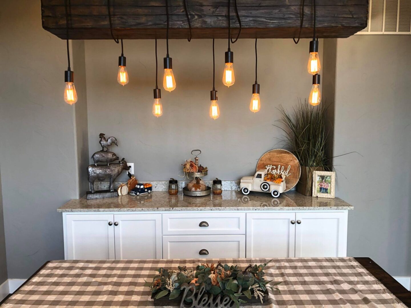 White cabinetry with light gray top placed with table decorations