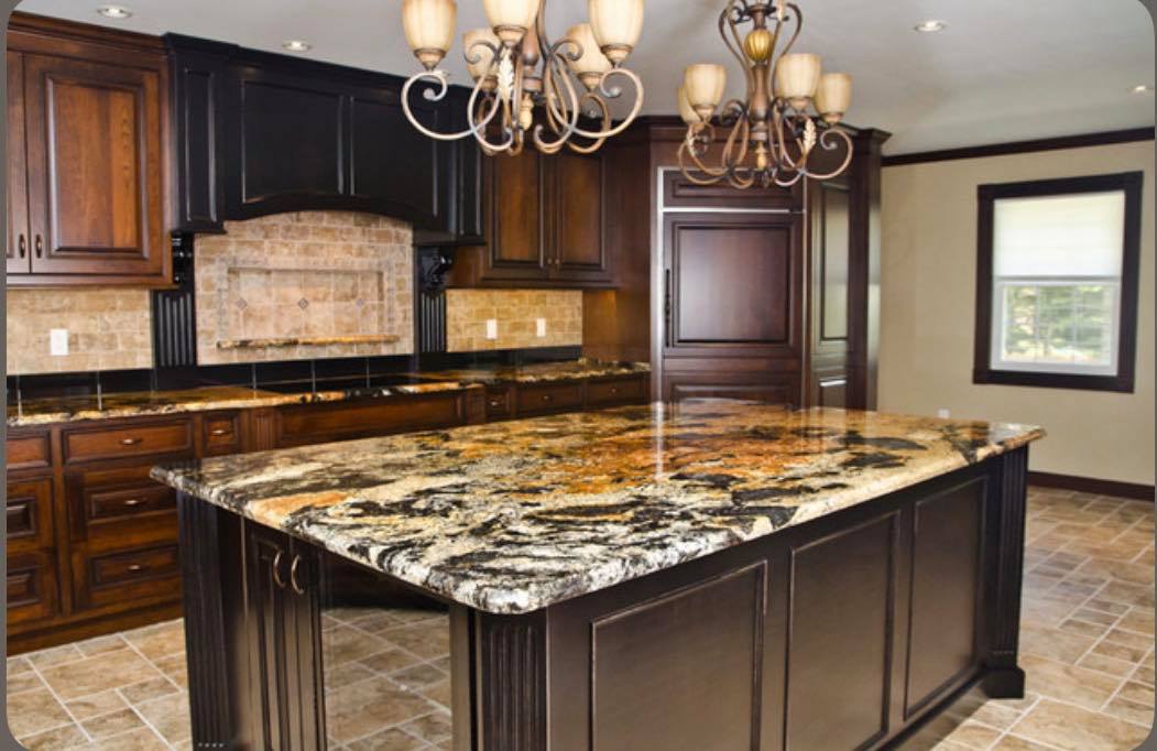 Wooden cabinetry, light beige walls, and dark brown countertops