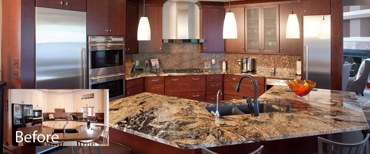 A kitchen with brown tiled walls and a dark brown countertop