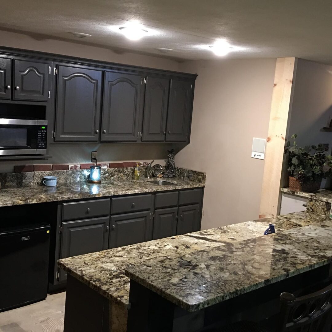 Black cabinetry and dark countertops